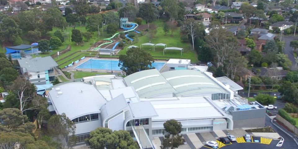 aerial view of the Aquarena facilities including the main building and the outdoor pools and green space