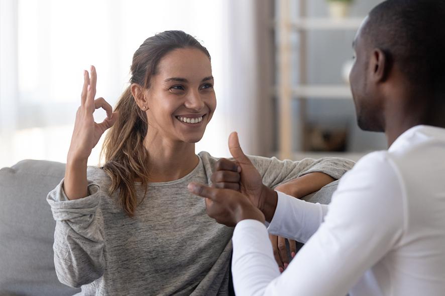 Two people speaking sign language