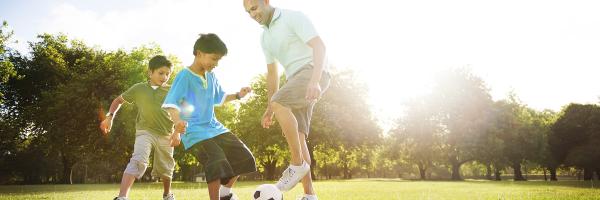 Family playing soccer