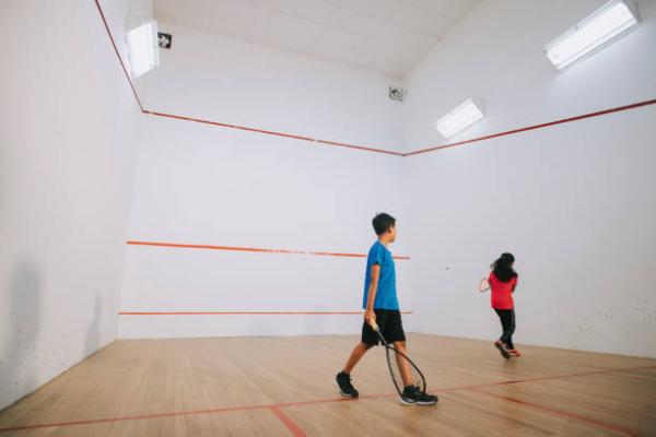 2 Children playing Squash. 
